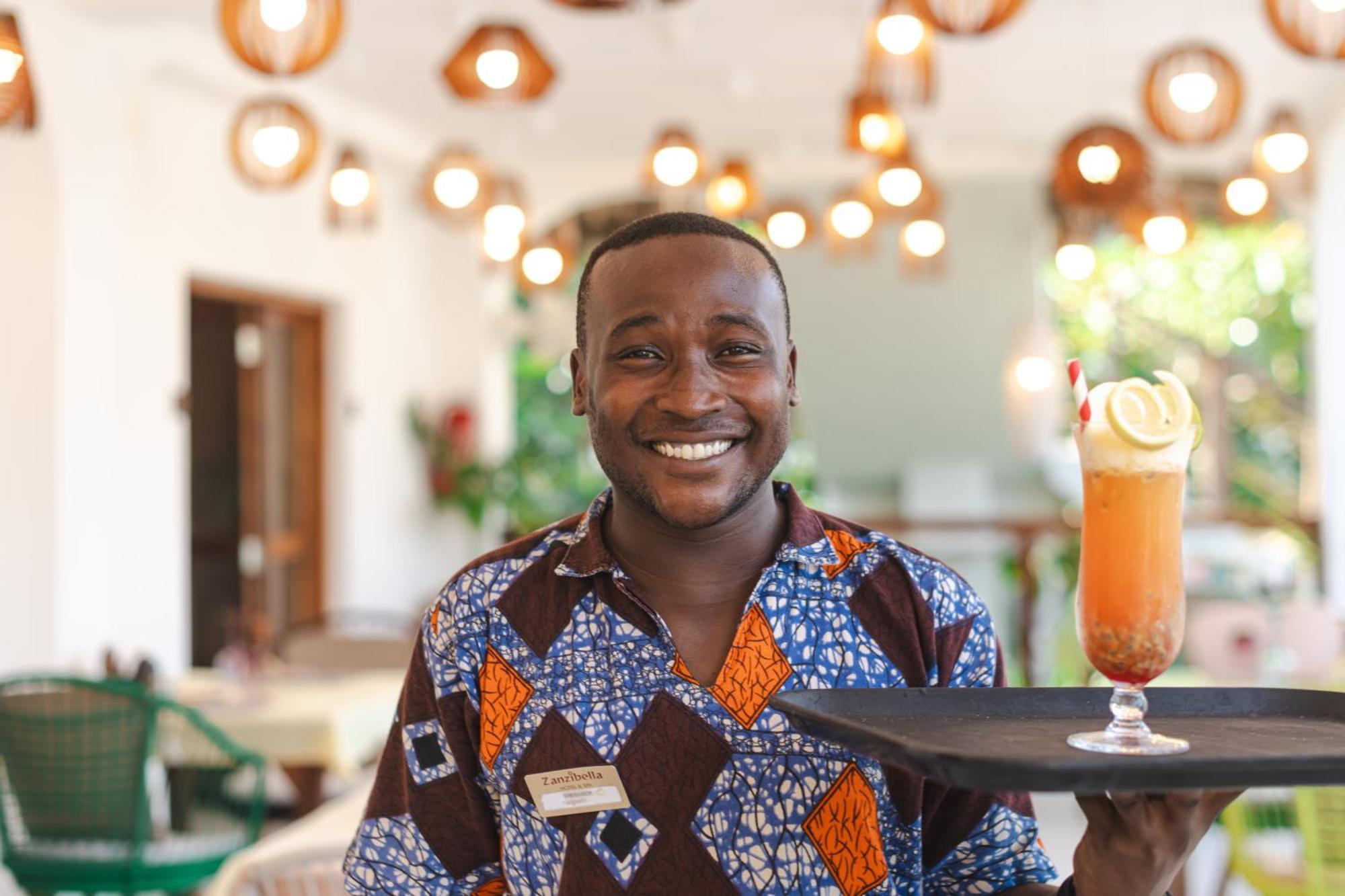 Zanzibella Hotel & Spa Kiwengwa (Zanzibar) Exterior foto A waiter at the Serena Hotel in Kampala, Uganda